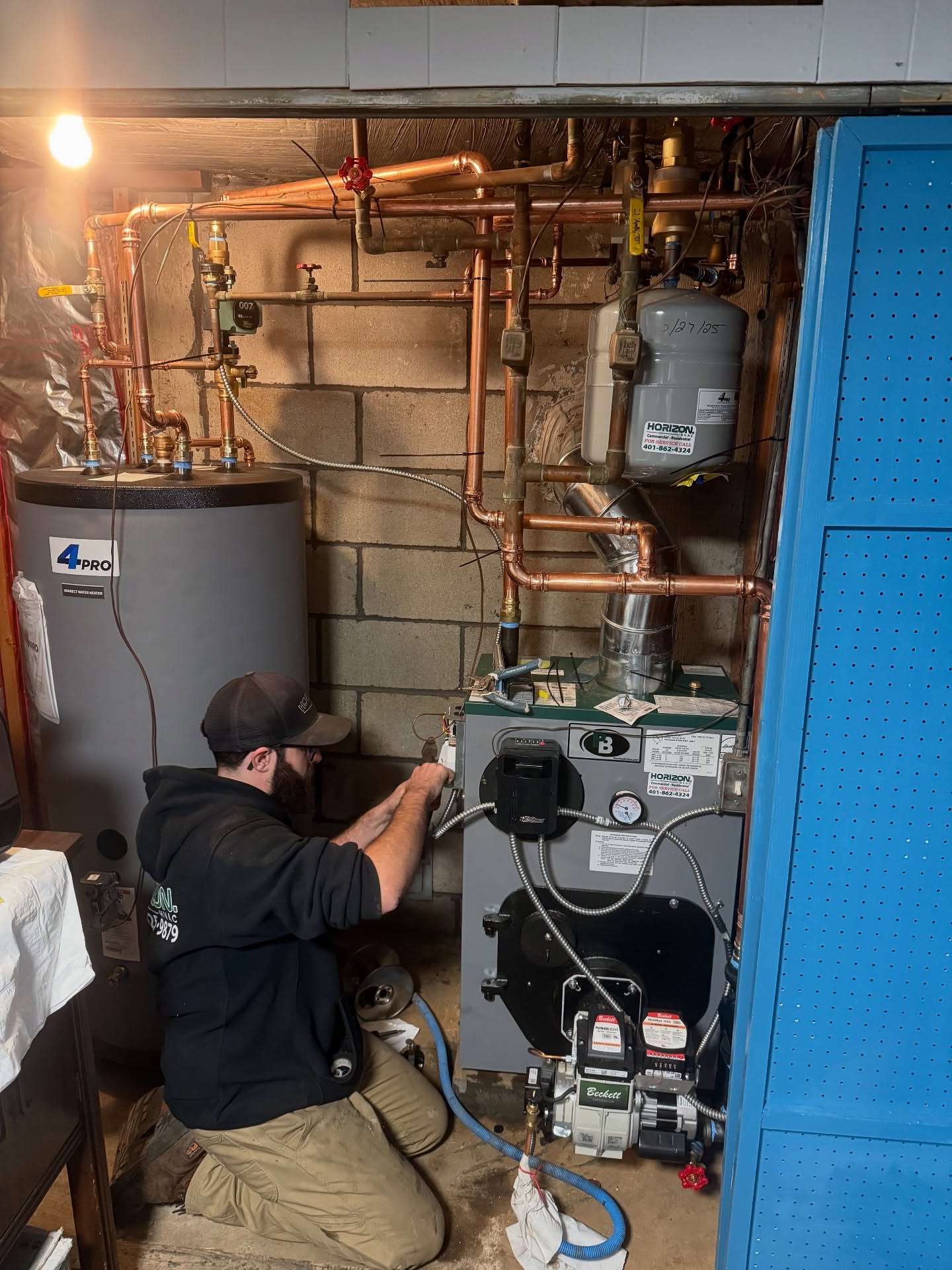 Horizon HVAC technician servicing a boiler and copper piping