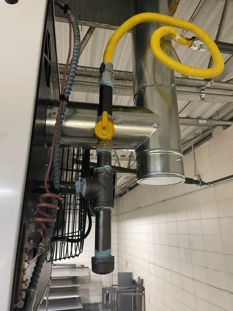 Gas piping and venting on a commercial unit heater installed by Horizon HVAC