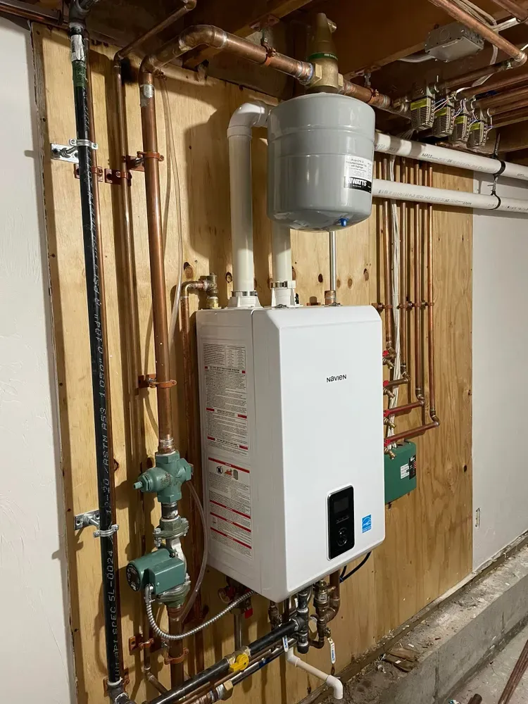 Navien combi boiler installed by Horizon HVAC with copper piping and circulator pumps